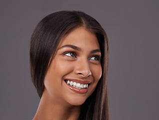 Image showing Thinking, hair and face of happy woman on gray background for healthy texture, wellness and beauty. Smile, hairdresser and person with long hairstyle for salon products, cosmetics and shine in studio