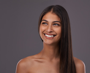 Image showing Happy, hair and face of woman on gray background for healthy texture, wellness and beauty. Haircare, hairdresser and person with long hairstyle for salon products, cosmetics and shine in studio