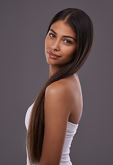 Image showing Portrait, hair care and beauty of woman in makeup, glow or shine isolated on gray studio background. Face, hairstyle and Indian model in cosmetics at salon for skincare treatment, hairdresser or body