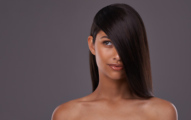 Image showing Woman, studio and haircare with thinking beauty, Indian female person with luxury and salon treatment. Brazilian and keratin blowout for results and wellness, confident and isolated glowing model