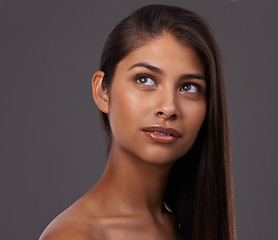 Image showing Hair care, beauty and skincare of woman in makeup, shine and thinking isolated on a gray studio background. Hairstyle, cosmetics and young Indian model at hairdresser, salon and facial treatment
