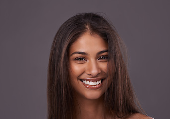 Image showing Portrait, hair or beauty of happy woman, glow or shine in makeup isolated on gray studio background. Face, hairstyle or Indian model in cosmetics at salon for skincare treatment, hairdresser or care