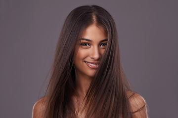 Image showing Portrait, hair and beauty of happy woman with wind, glow or shine in makeup isolated on gray studio background. Face, hairstyle or Indian model in cosmetics at salon for skin treatment at hairdresser