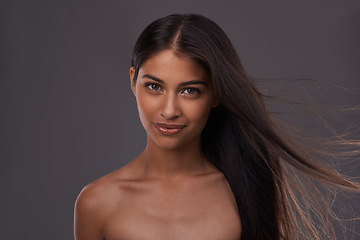 Image showing Hair care, wind and portrait of woman with beauty, shine or skincare isolated on a gray studio background. Hairstyle, cosmetics and face of Indian model in salon with makeup at hairdresser for glow