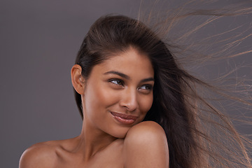 Image showing Wind, smile and closeup of woman for hair care, treatment and blow dry for cosmetology isolated on studio background. Female person, adult and hairstyle for shampoo, hairdressing and brushing
