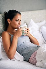 Image showing Woman, drinking coffee and bed thinking for relax in morning on weekend or home break, day off or leisure. Female person, beverage and linen in apartment with thoughts for Sunday, resting or calm