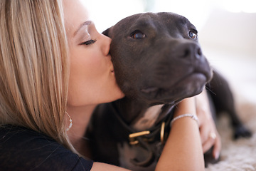 Image showing Love, kiss or woman and dog in a house with trust, care and bonding at home together. Pets, face and female person relax with pitbull puppy hug in living room for security, attention or foster safety