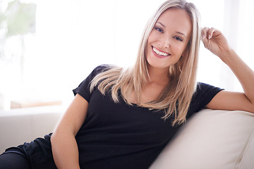 Image showing Portrait, happy and woman on a sofa relax with confidence, positive attitude or feel good mood in her home. Face, smile and female person in a living room with vacation, free time or resting holiday