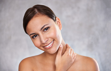 Image showing Portrait, natural beauty and woman with smile for cosmetic care, shine and hand touching skin on grey background. Dermatology, wellness and hygiene, moisturizing body for glow and clean skincare