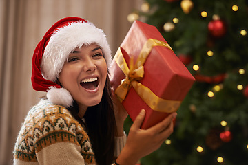 Image showing Christmas, excited and portrait of woman with present at her home for festive celebration, event or party. Smile, happy and young female person with gift box for xmas surprise in living room at house