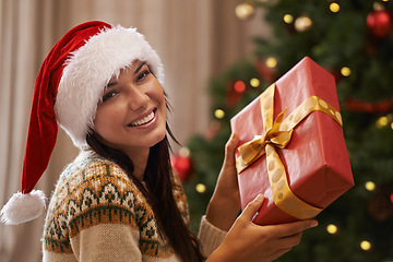 Image showing Christmas, smile and portrait of woman with present at her home for festive celebration, event or party. Excited, happy and female person with gift box for xmas surprise in living room at apartment.