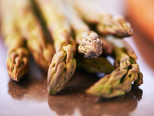 Image showing Natural, vegetable and asparagus for cooking, food and nutrition at home, house and kitchen with macro on table. Sparrow grass, edible plants and fresh produce for vegan dish, clean eating and salad