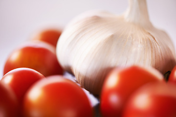 Image showing Home, garlic and tomatoes with kitchen counter, ingredients and groceries with recipe and healthy. Wellness, closeup and mockup space with vegetables and nutrition with vegan and organic food