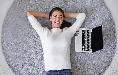 Image showing Happy woman, portrait and relax with laptop on floor above for break, rest or research at home. Top view of female person or freelancer with smile, computer or carpet rug with mockup screen at house