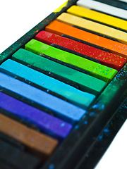 Image showing Paint, pastel and artist chalk in studio for rainbow or vibrant creativity, texture and pigments for fine or visual arts. Oil or watercolor sticks, color or palette to shade or blend with composition