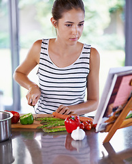 Image showing Cooking, cutting and kitchen with woman, vegetables and book with recipe and ingredients. Home, girl and person with skills and nutrition with diet plan and lunch with healthy meal and vegetarian