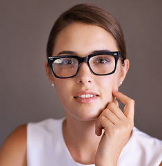 Image showing Portrait, studio and woman thinking with glasses for vision, eyesight and professional employee. Worker, smile and female person contemplating career in corporate company in New York for startup