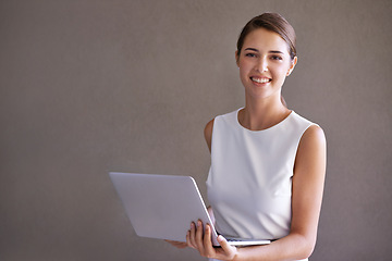 Image showing Business, portrait and woman with laptop, smile and entrepreneur on a studio background. Person, connection or PR consultant with a computer or internet with website information, tech or confidence