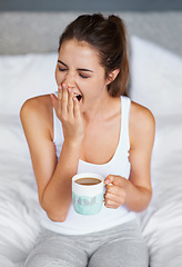 Image showing Woman, fatigue and yawning with tea in bed, waking up from sleeping or nap with morning routine at home. Insomnia, tired and sleepy in bedroom, warm drink or beverage for breakfast and start day