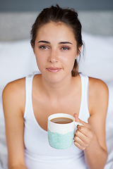 Image showing Woman, coffee and portrait in bed for tired in morning for wakeup and drink in cup for warm and strong with milk. Young person with beverage for caffeine on weekend for boost in mug with pajamas