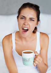 Image showing Woman, tired and yawning with coffee in bed, waking up from sleeping or nap with morning routine at home. Insomnia, fatigue and sleepy in bedroom, warm drink or beverage for breakfast and start day