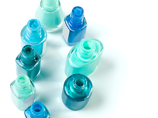 Image showing Nail polish, blue color and bottle on a white background for beauty, cosmetics and salon products. Cosmetology, luxury spa and isolated jar for manicure, pedicure and pamper aesthetic in studio