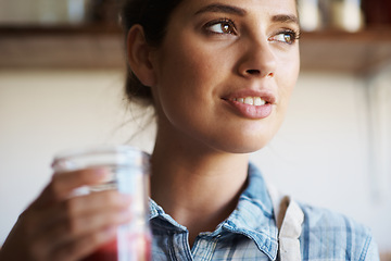 Image showing Woman, glass and juice with kitchen, closeup and person with smoothie for health or wellness. Nutritionist, drink and beverage for nutrition, vitamins and vitality for juicing diet with apron at home