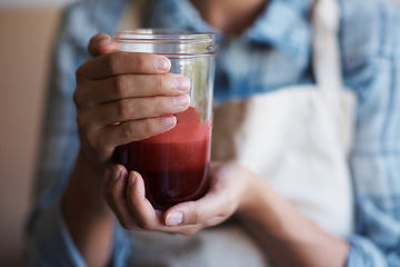 Image showing Hands, glass and juice with kitchen, closeup and person with smoothie for health and wellness. Chef, drink and beverage for nutrition, vitamins and vitality for juicing diet with apron at home