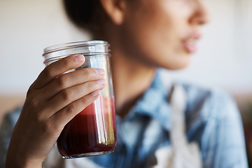 Image showing Glass, hand and smoothie with woman in kitchen of home closeup for diet, health or nutrition. Detox, juice for weight loss and person in apartment with fresh fruit beverage for minerals or vitamins