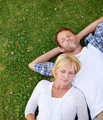 Image showing Love, sleeping and couple in nature with peace, relax or top view chilling on holiday, vacation or resting outdoor. Calm, above or people lying in grass for sleep, nap or snooze on countryside trip