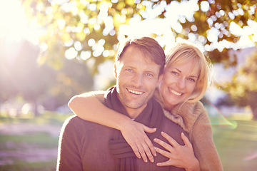 Image showing Hug, portrait and couple in a park with love, support and romance at sunset outdoor. Travel, face and people embrace in nature with security, fun or bonding on adventure, journey or holiday trip