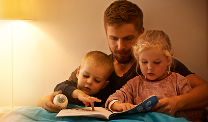 Image showing Night, kids or dad reading book in bed for learning, education or storytelling in a home for care. Family, relax or father with children siblings for a fantasy with a girl, boy or support for love