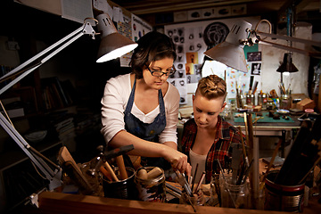 Image showing Women, craft and tools in workbench for creative design, wood sculpture or handmade project at night. Artist, collaboration and manufacturing in studio with teamwork, assistance and workshop skills