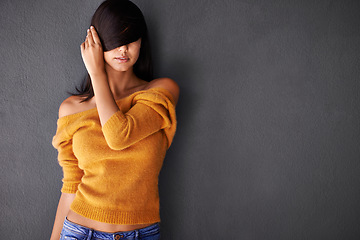 Image showing Woman, hand and hair in studio cosmetics, style and haircare with pride or confidence. Female person or model, fashion and trendy or cool in mockup space, casual outfit in gray background