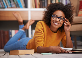 Image showing Portrait, floor and African woman in library, smile and study for education. Textbooks, paper and glasses material for happy female student with natural afro hair, learning and notes for knowledge