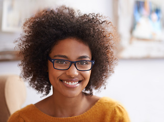 Image showing Portrait, smile and relax woman in home lounge, happy and eyewear for natural lady. Head, confidence and glasses with curly hair for female person from London, positive in living room or apartment