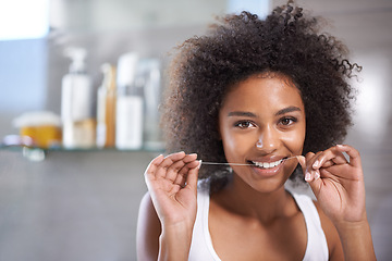 Image showing Black woman, portrait and floss for teeth in bathroom, dental health and wellness for fresh breathe at home. String, thread and product for oral hygiene with morning routine and orthodontics