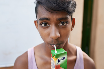 Image showing Portrait, teenager and drinking juice outdoor for healthy diet, wellness or nutrition in India. Face, boy and beverage with straw in box for benefits, energy and organic liquid fruit for hydration