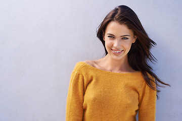 Image showing Portrait, fashion and happy woman on a wall with wind in hair isolated on purple background mockup space. Smile, face and beauty of young person in casual clothes, trendy or stylish sweater in Italy