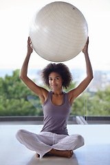 Image showing Woman, portrait and balance ball for fitness and wellness in studio with exercise and health on the floor. Happy African person with workout, pilates and holding arms up for power, strength and body