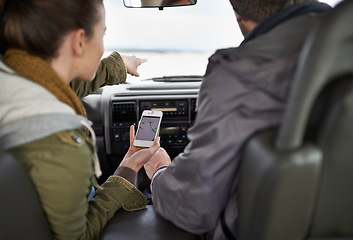 Image showing Road trip, couple and smartphone for navigation in car, adventure and connectivity for travel exploration in nature. People, mobile app and bonding together on holiday, journey and honeymoon in oman