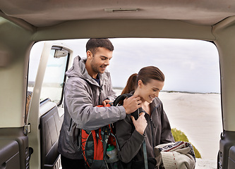 Image showing Jeep, man and woman outdoors for backpacking on vacation for adventure or travel, active and gear for road trip. Male, female explorers, tourists and car for camping and trekking, journey and nature.