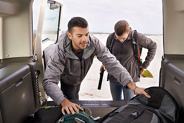 Image showing Car, man and woman outdoors for backpacking on vacation for adventure or travel, active and gear for road trip. Male, female explorers, tourists and jeep for camping and trekking, journey and nature.