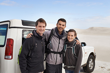 Image showing Car, portrait and friends in a desert for road trip, hug or bonding on adventure in nature. Travel, face and people stop in sand dunes for journey, break or fun vacation outdoor together in Egypt