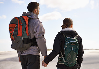 Image showing Travel, backpack or couple in desert holding hands for adventure, journey or resort, location or explore. Freedom, love or back of people in Egypt for sand dunes walking, wellness or hiking in nature