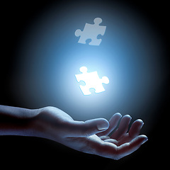 Image showing Puzzle, piece and abstract solution in hand for problem solving, challenge and planning with strategy. Jigsaw, games or shape of idea to glow in light of dark and search for innovation in business