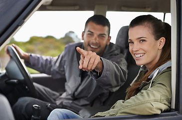 Image showing Couple, car and pointing on roadtrip with travel for adventure, vacation or sightseeing with happiness in countryside. Woman, man or driving in vehicle for holiday journey, tourism and honeymoon trip