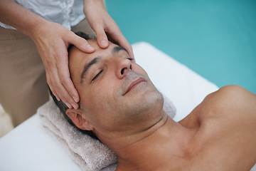 Image showing Resort, spa and man relax for massage on table in hotel, calm and care for body in vacation. Holiday, luxury and male person on break for weekend, accommodation and lodge with treatment for skincare