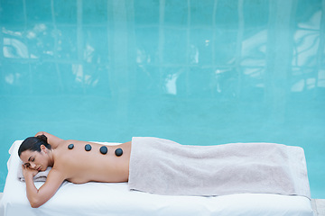 Image showing Spa, hot stone massage and woman at pool at hotel for health, zen wellness and luxury holistic treatment. Self care, relax or girl on table for body therapy, comfort and calm pamper service in mockup