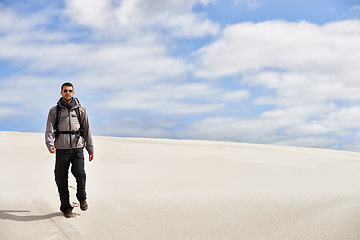 Image showing Travel, backpack or fitness man in desert for adventure, journey or resort, location and exploration. Freedom, holiday or male backpacker in Egypt for sand dunes walking, wellness or hiking in nature